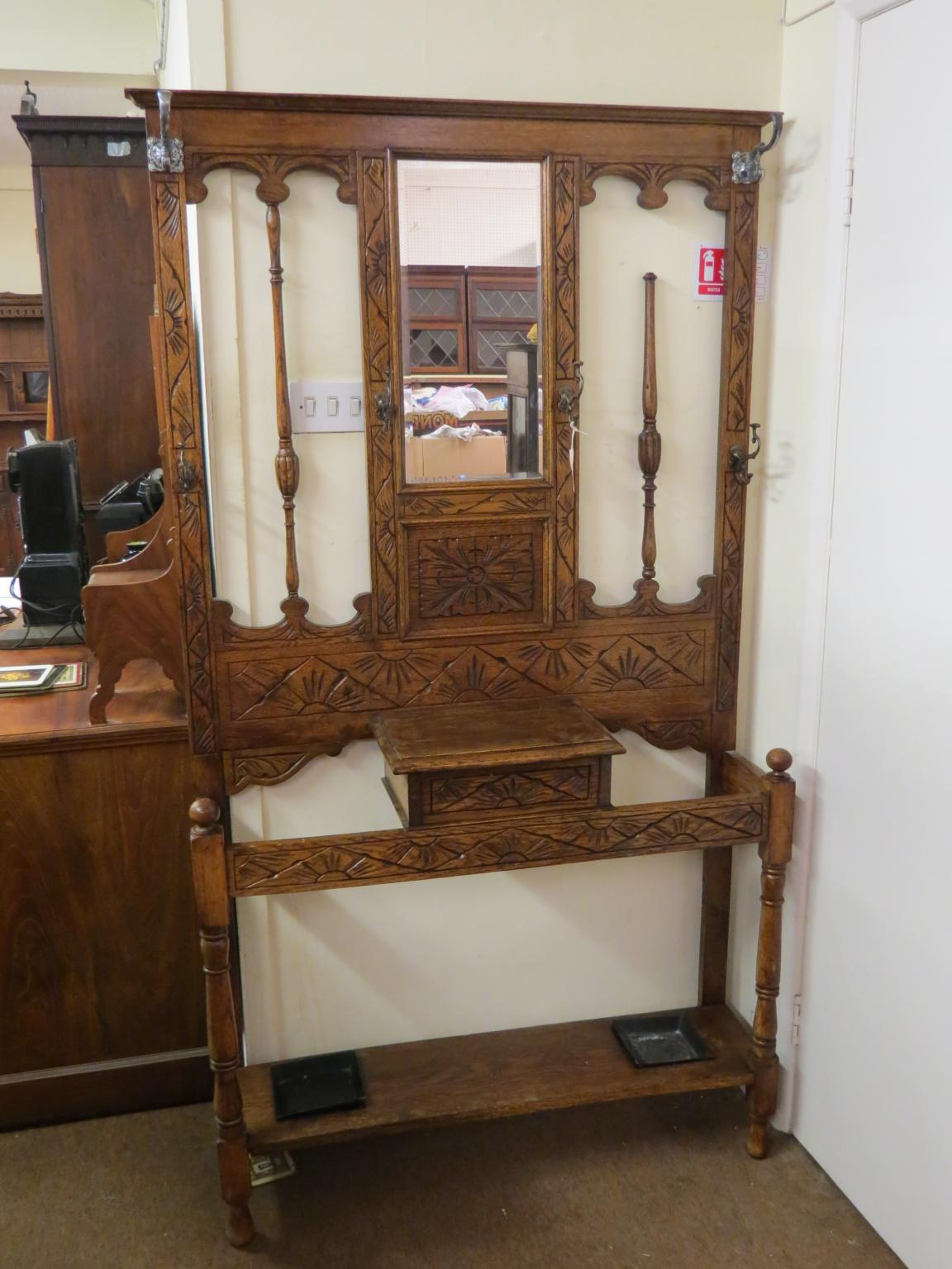 Appraisal: A solid medium oak hall stand with carved and turned