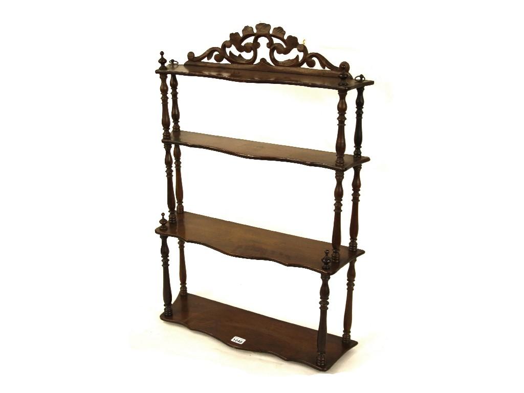 Appraisal: th century serpentine mahogany four tier wall shelf with a