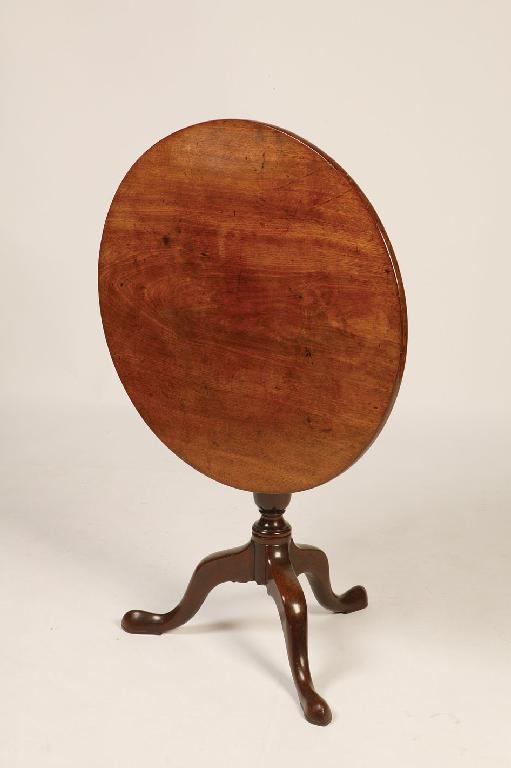 Appraisal: A GEORGE III MAHOGANY CIRCULAR ONE PIECE TOP TIP-TOP OCCASIONAL