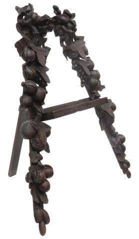 Appraisal: Black Forest style carved wood tabletop easel display stand th