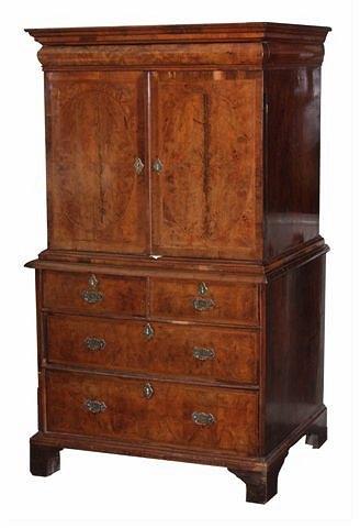 Appraisal: A WILLIAM MARY FIGURED WALNUT CABINET ON CHEST the moulded