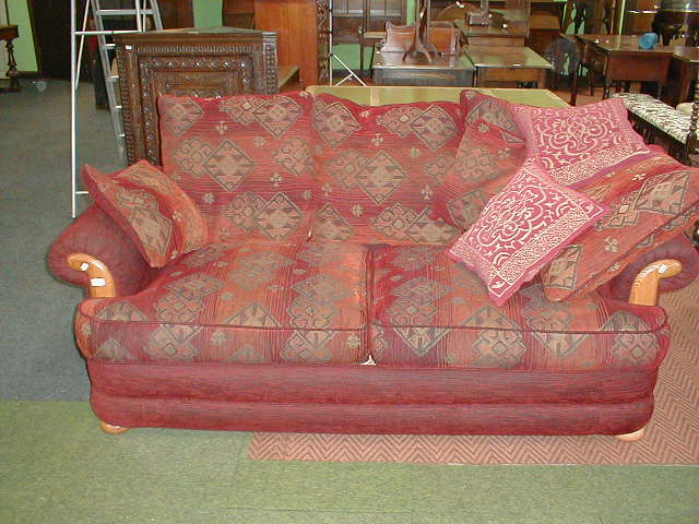 Appraisal: A modern three-seater sofa with loose cushions