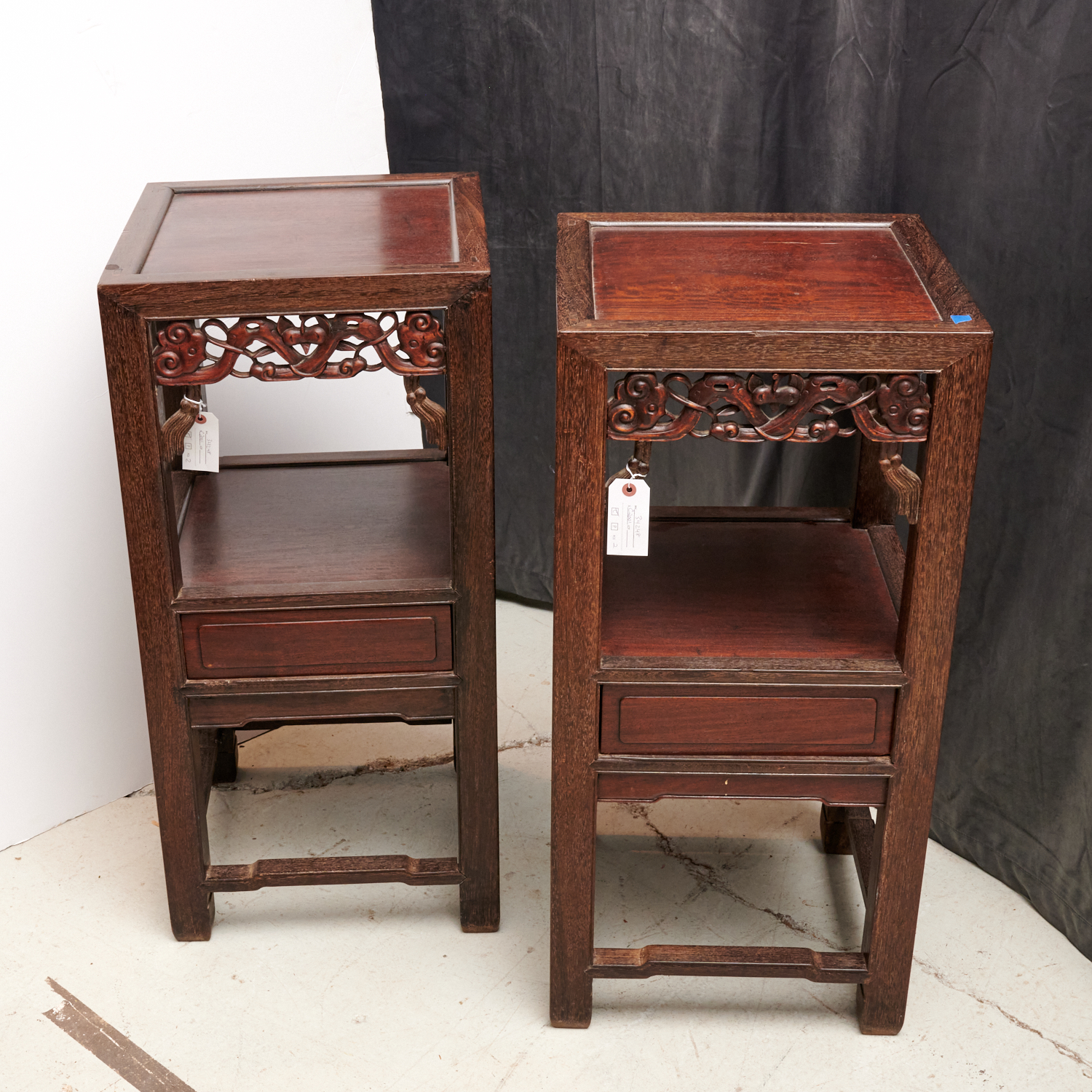 Appraisal: PAIR CHINESE CARVED HARDWOOD TIERED STANDS th th c two-tier