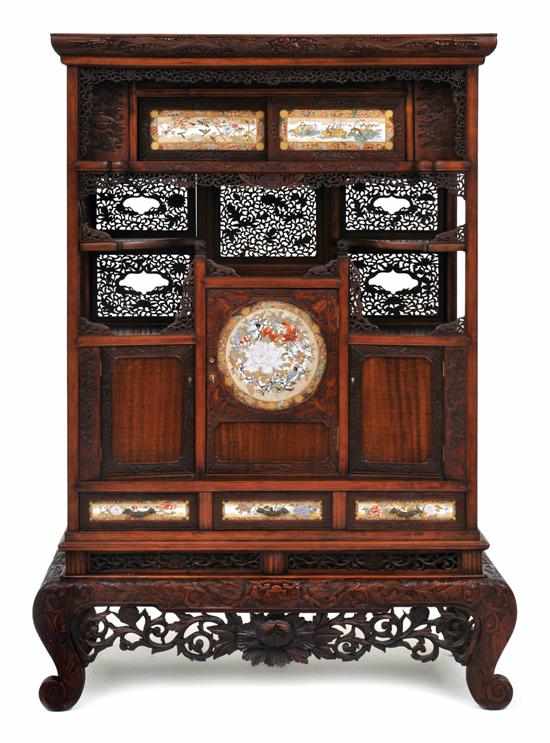 Appraisal: A Japanese rosewood and satsuma panelled display cabinet on stand