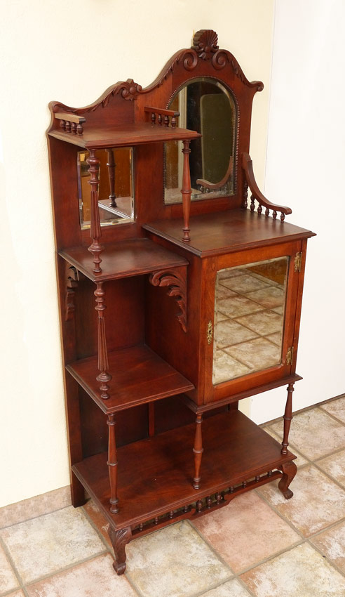 Appraisal: WALNUT ETAGERE DISPLAY CABINET Carved shaped crest right side with