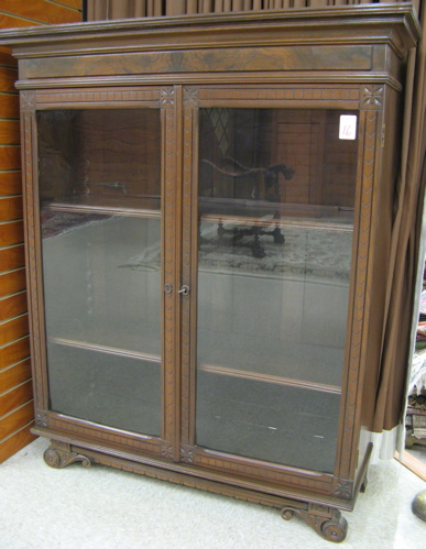 Appraisal: VICTORIAN WALNUT CABINET BOOKCASE American c having a molded cornice