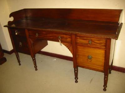 Appraisal: A MAHOGANY SIDEBOARD the gadroon edged top with raised three