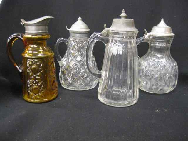 Appraisal: Victorian Glass Syrup Pitchers one amber and three clear pattern