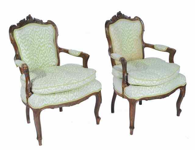 Appraisal: A PAIR OF FRENCH WALNUT SALON CHAIRS with carved cresting