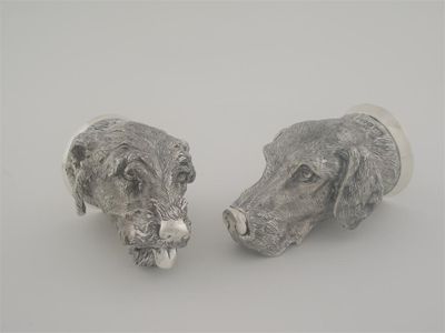 Appraisal: Two contemporary cast hunting-dog mask stirrup cups one perhaps a