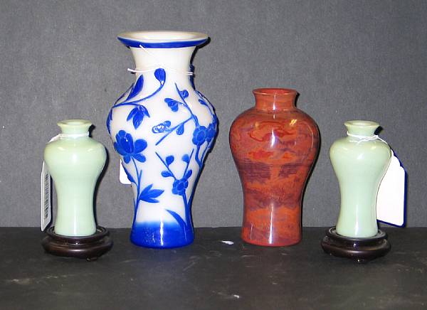 Appraisal: Four glass vases The first a milk white baluster vase