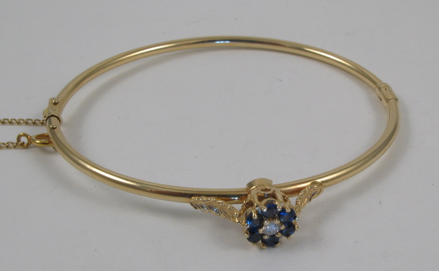 Appraisal: SAPPHIRE AND DIAMOND BANGLE k yellow gold and set with