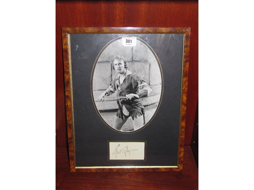 Appraisal: Publicity photograph of Errol Flynn with likely facsimile autograph