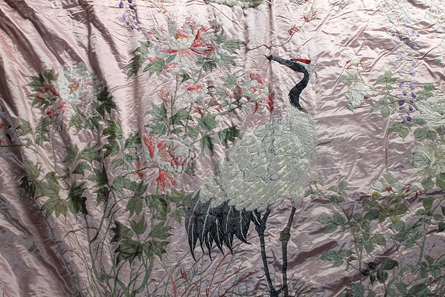 Appraisal: A LARGE ORIENTAL PINK GROUND COVER embroidered with cranes and