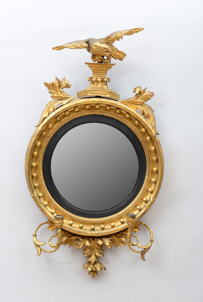 Appraisal: REGENCY GILTWOOD CONVEX MIRROR Fitted with a pair of scrolled