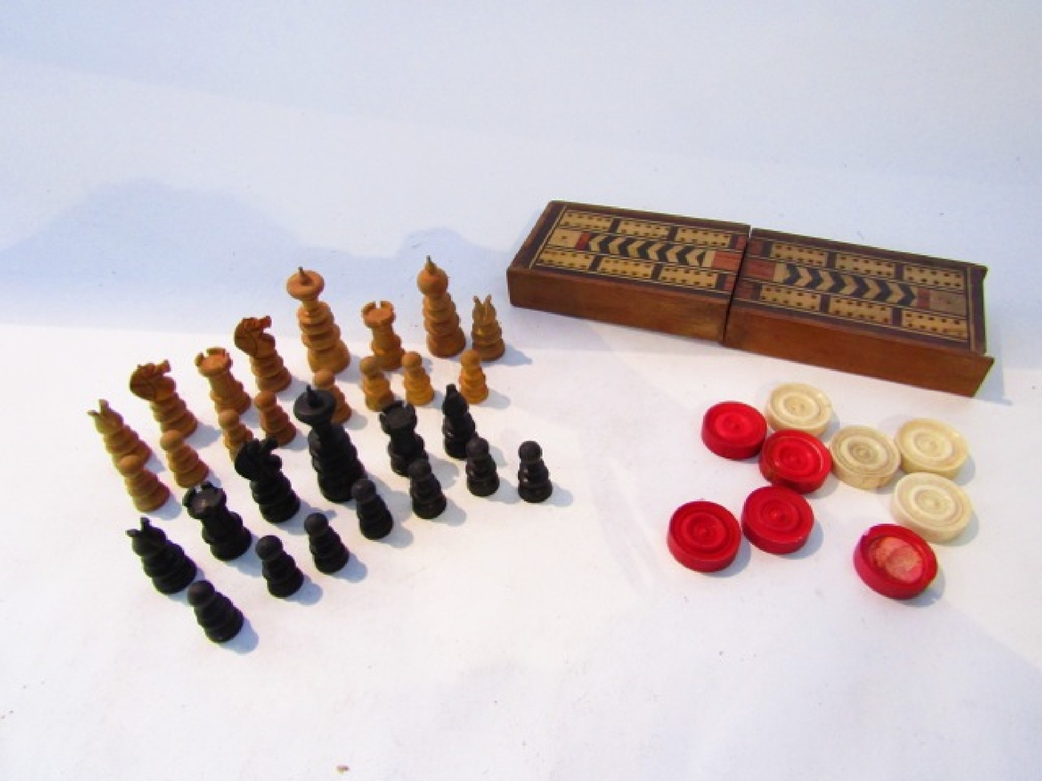 Appraisal: An antique turned timber chess set pieces in fruitwood in