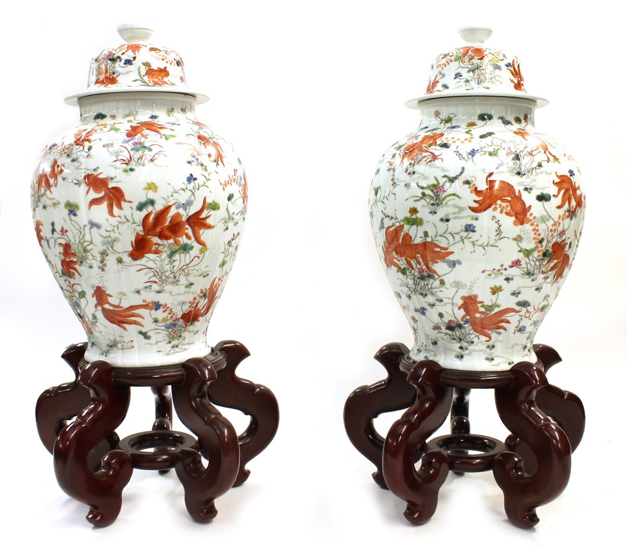 Appraisal: A pair of Chinese famille-rose ribbed baluster vases and covers