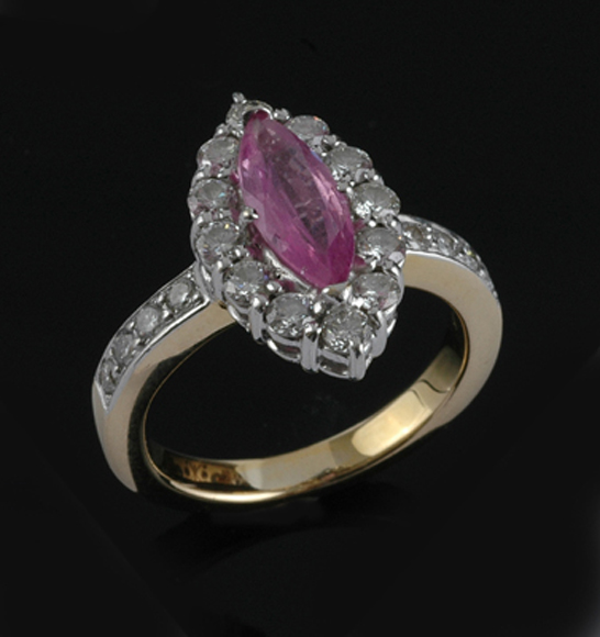 Appraisal: A pink sapphire and diamond ring The marquise cut sapphire