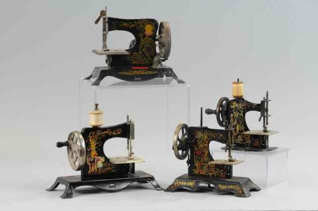 Appraisal: GROUPING OF TOY SEWING MACHINES Cast iron examples each with