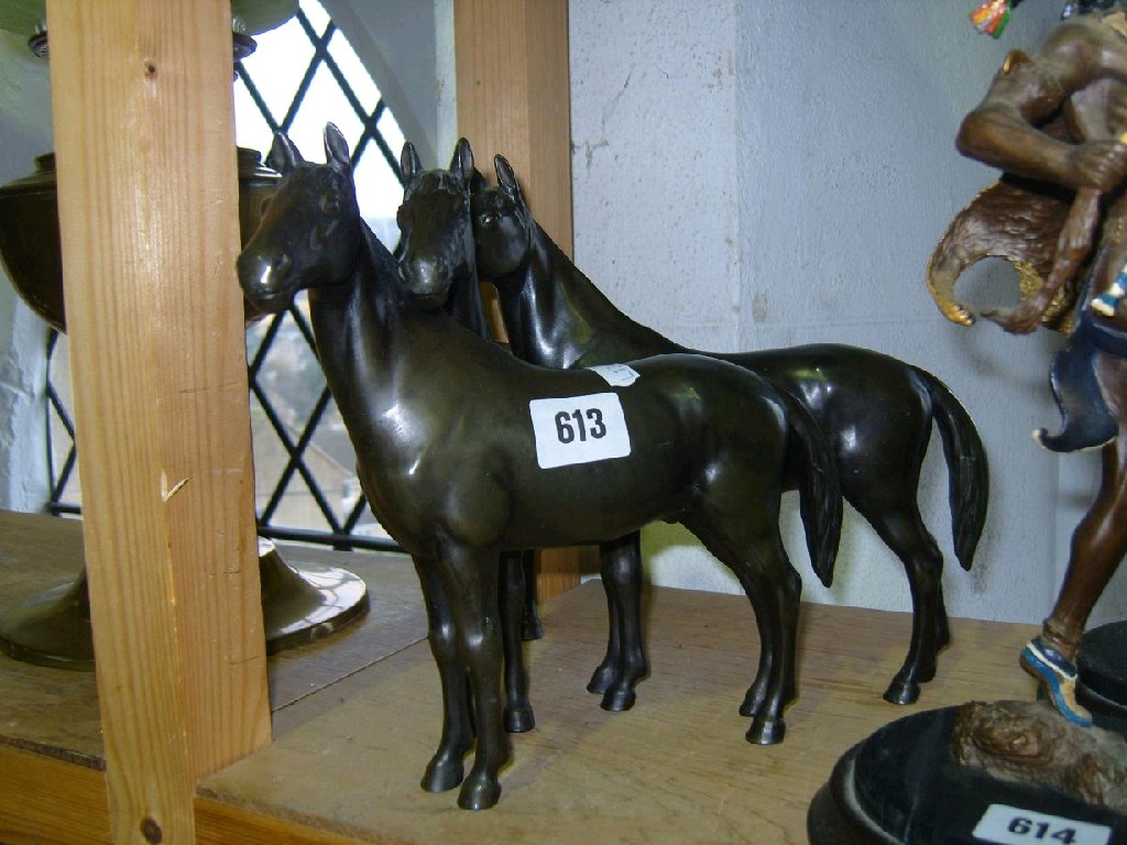 Appraisal: A cast bronzed group of three standing horses