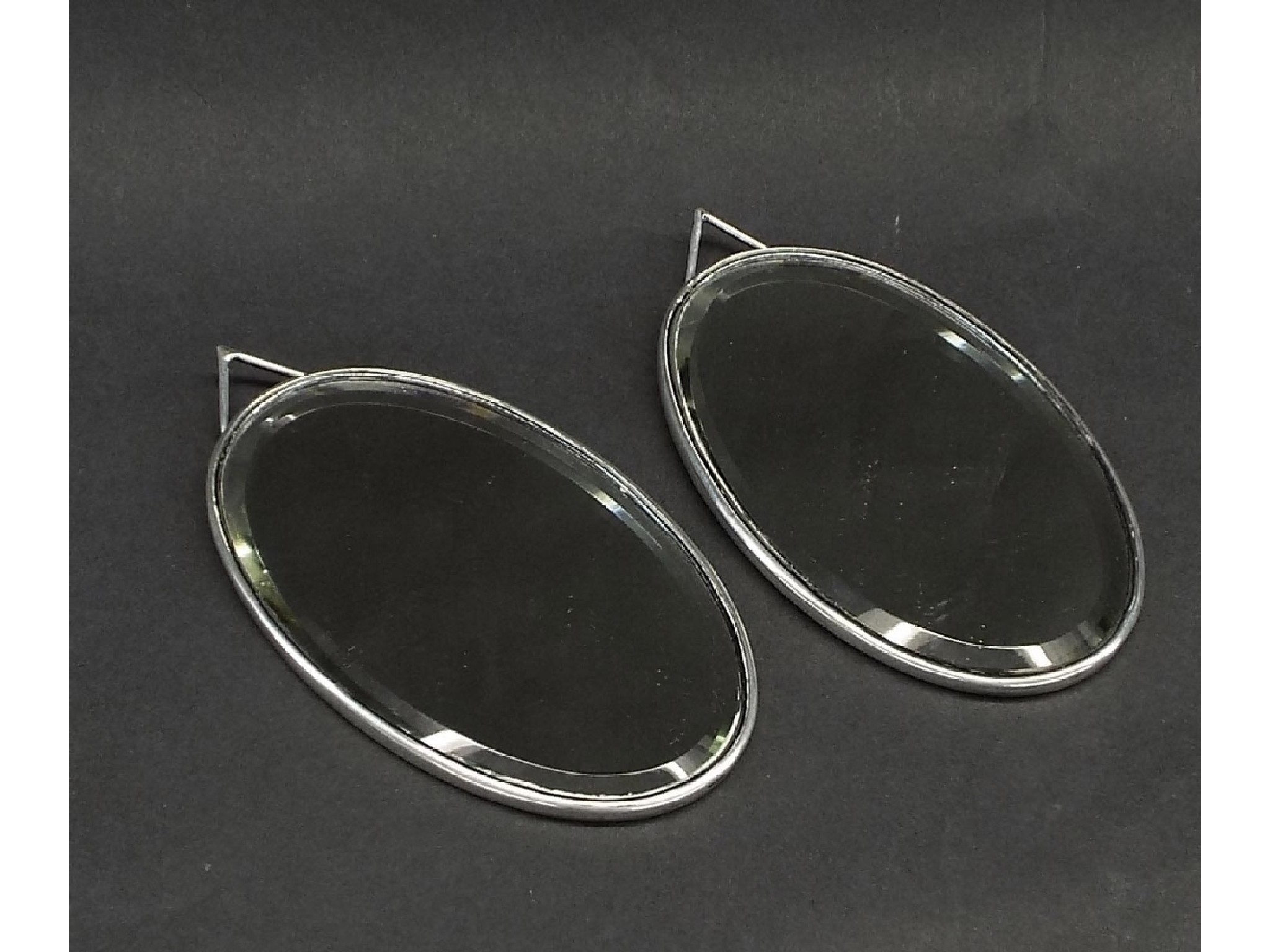 Appraisal: Small pair of silver framed oval bevel edge mirrors maker