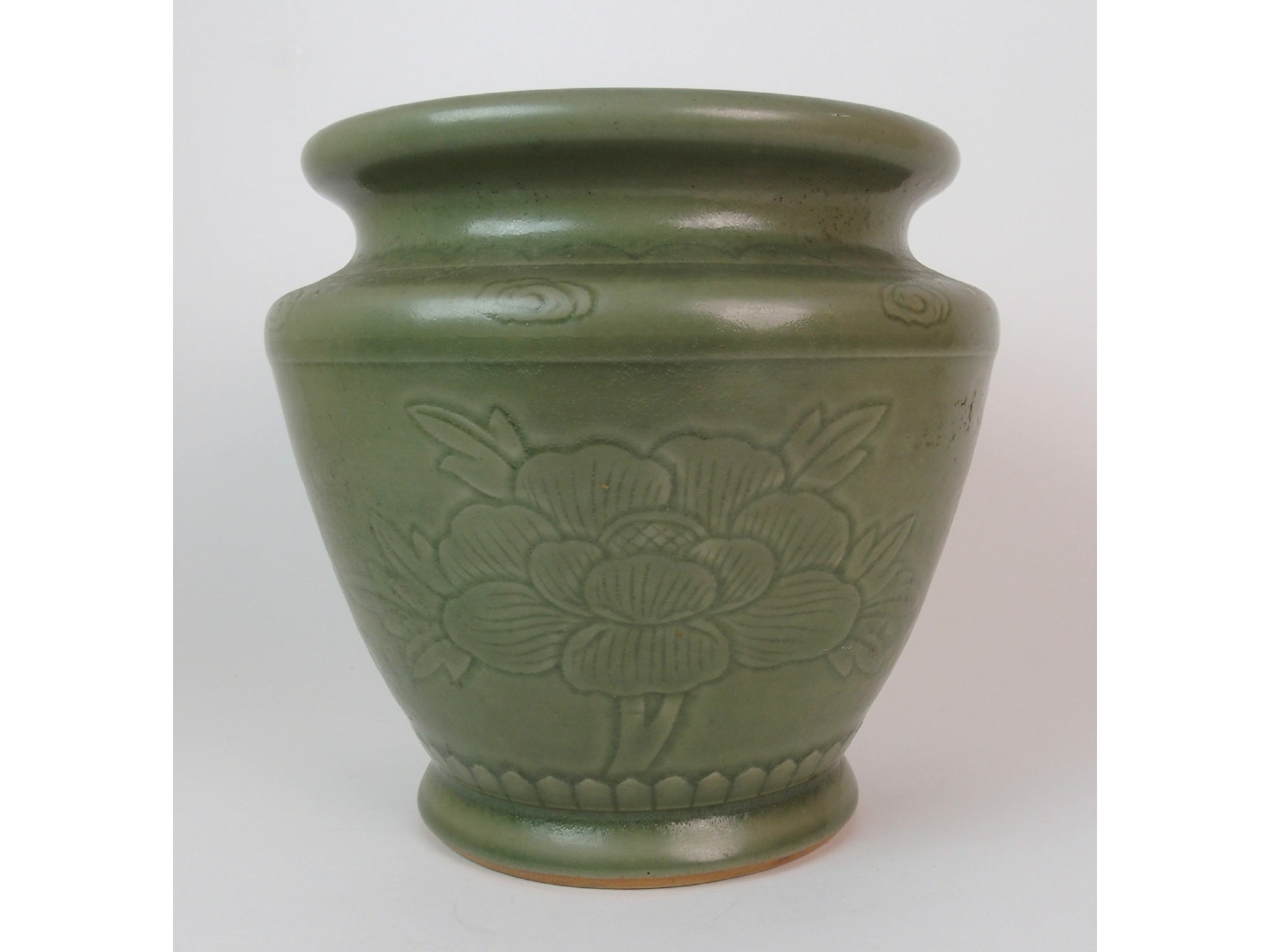 Appraisal: A Chinese Celadon ground jardiniereincised with large peony heads divided