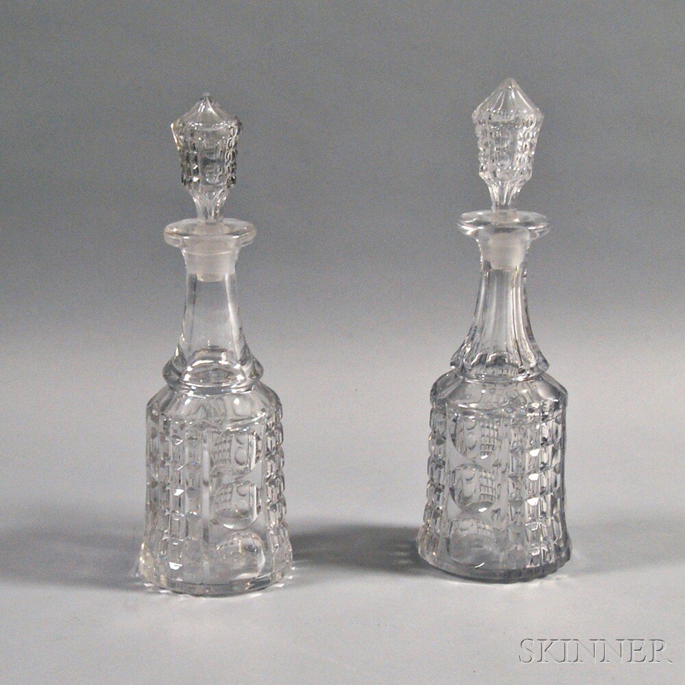 Appraisal: Pair of Pressed Glass Decanters th century each with columns