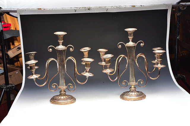 Appraisal: A PAIR OF TH CENTURY SHEFFIELD PLATED FOUR BRANCH CANDELABRA