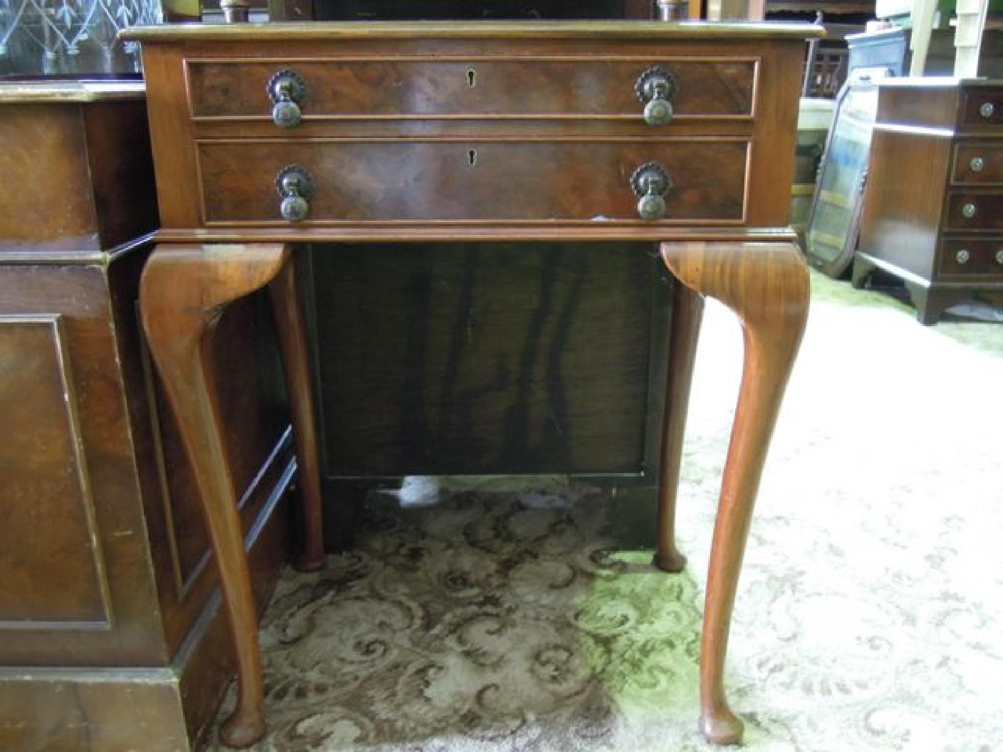 Appraisal: An Edwardian 's walnut and figured walnut veneered two drawer