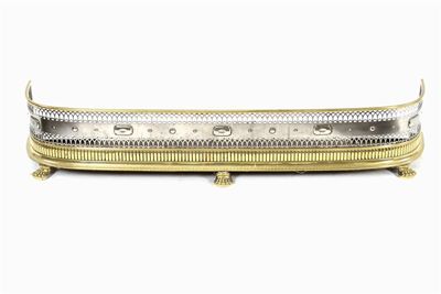 Appraisal: A Regency bowfront brass and steel fender with pierced and