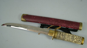 Appraisal: A tanto with cm etched blade moulded grip and gilt