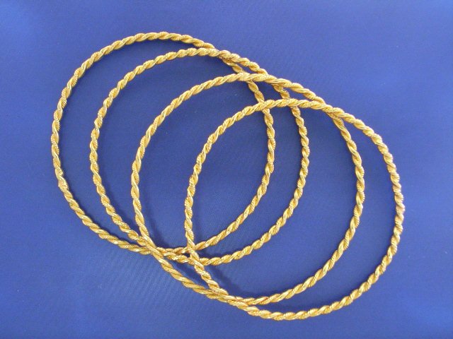 Appraisal: Four ct gold twisted wire bangles inner diameter mm gms