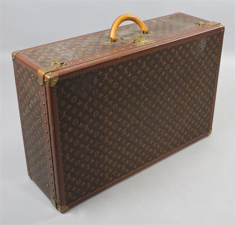 Appraisal: LOUIS VUITTON HARD SIDED SUITCASE trimmed with LV embossed tacked