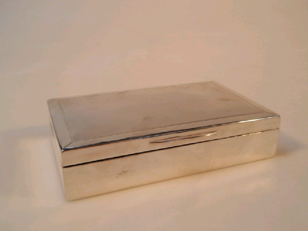 Appraisal: A silver cigarette box with engine turned decoration cedar lining