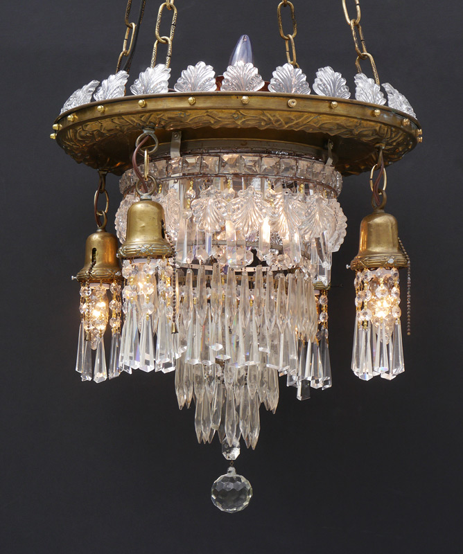 Appraisal: EMBOSSED BRASS CRYSTAL CHANDELIER Floral motif brass canopy with crystal