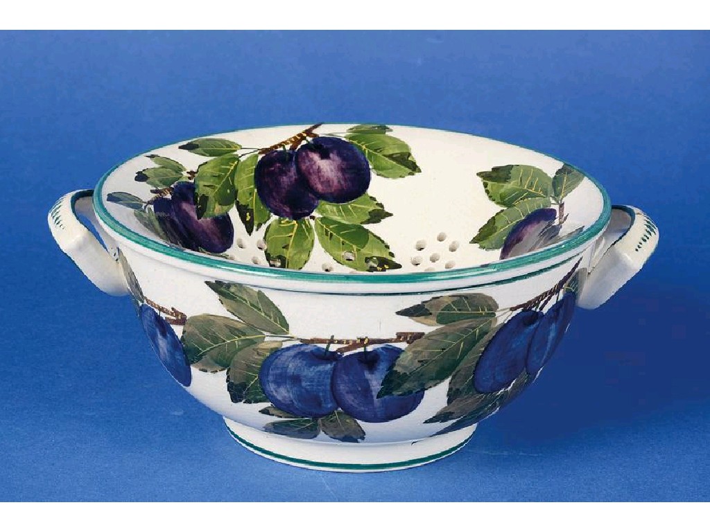 Appraisal: A WEMYSS FRUIT DRAINER AND BOWL painted with the plum