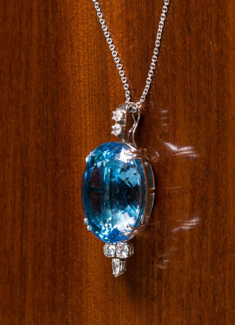 Appraisal: BLUE TOPAZ AND DIAMOND PENDANT NECKLACE with an k white