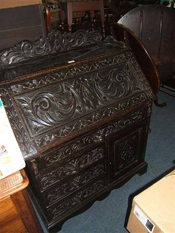 Appraisal: A late Victorian dark carved oak bureau wide