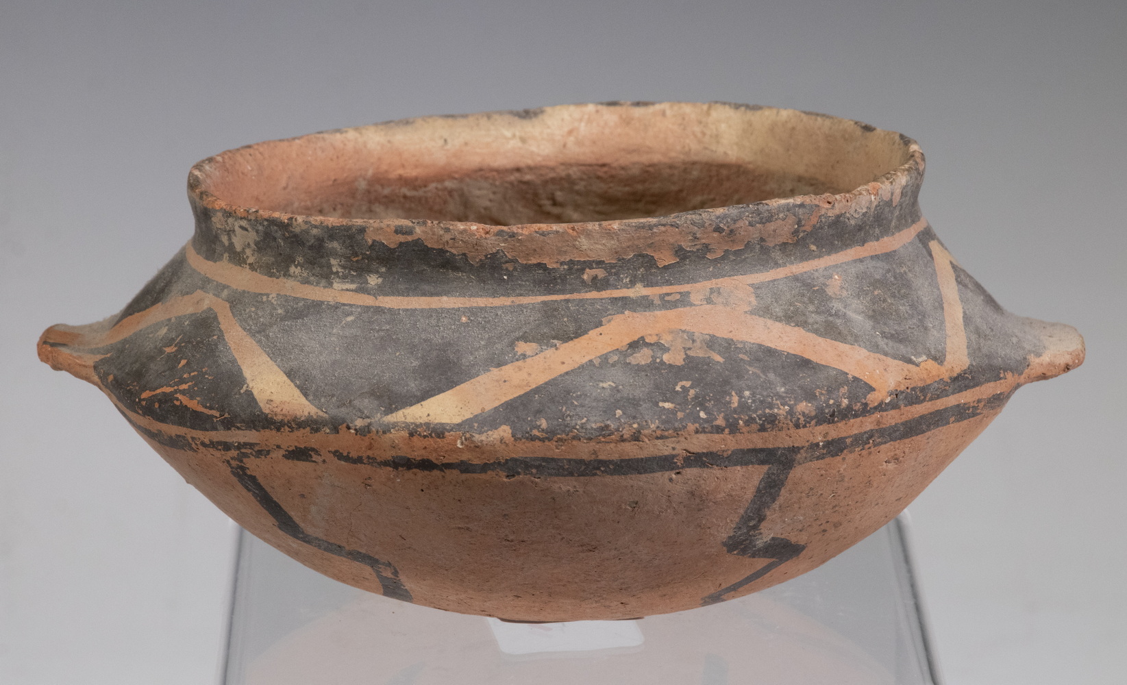 Appraisal: CHINESE NEOLITHIC PAINTED TERRACOTTA BOWL Painted pottery geometric pattern basin