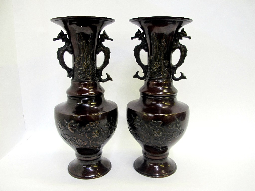 Appraisal: Pair of bronzed metal vases with relief floral decoration and