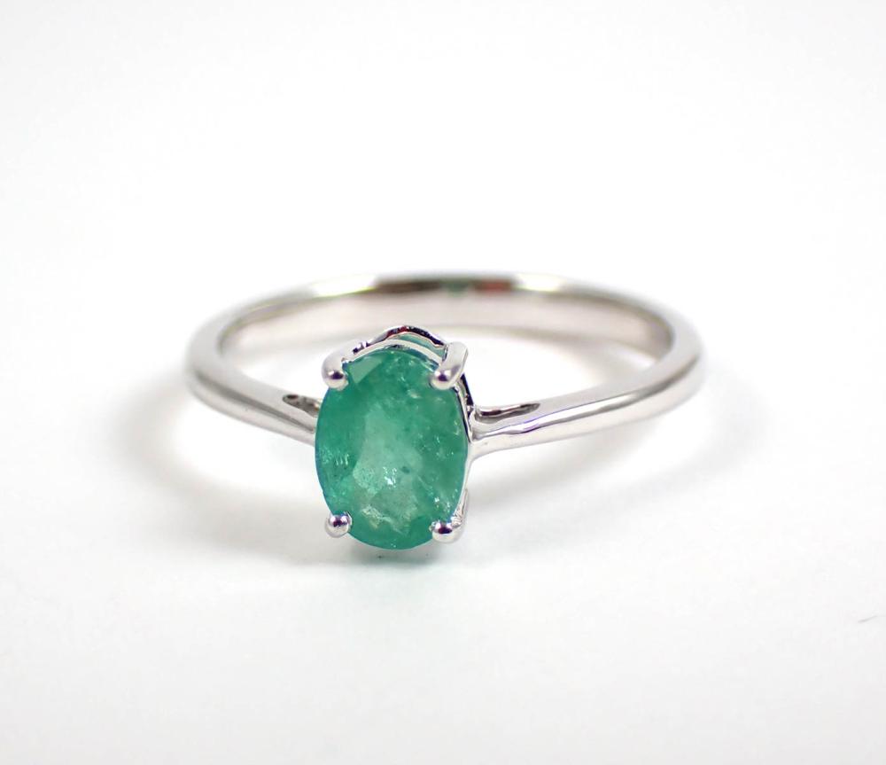 Appraisal: EMERALD AND FOURTEEN KARAT WHITE GOLD SOLITAIRE RING WITH APPRAISAL