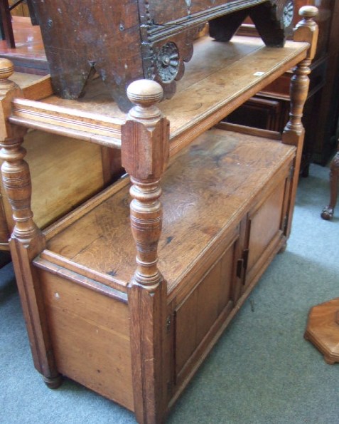 Appraisal: A late Victorian oak buffet the swan neck back over