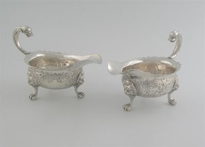 Appraisal: A pair of George II sauceboats on three lion mask