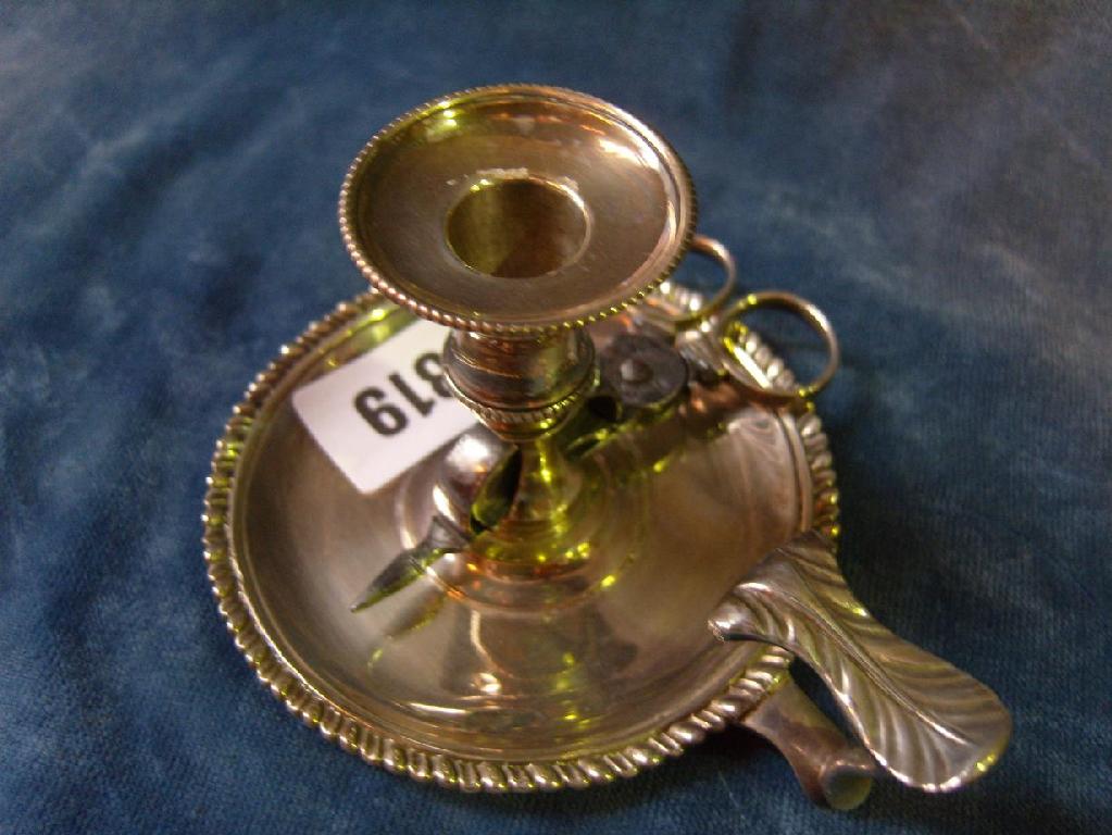 Appraisal: A Georgian silver chamberstick with shaped thumb piece beaded borders