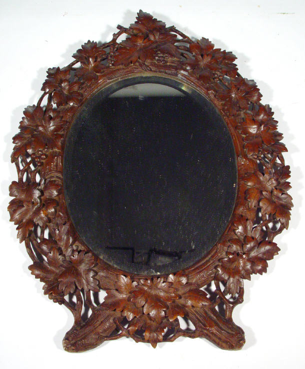 Appraisal: Oval Black Forest wooden mirror frame carved with leaves and