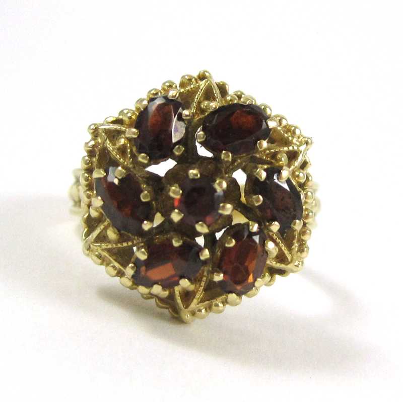 Appraisal: GARNET AND FOURTEEN KARAT GOLD RING set with six oval-cut