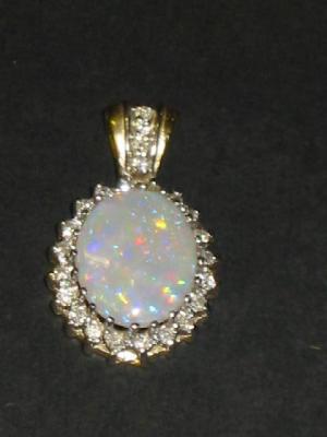 Appraisal: AN OPAL AND DIAMOND PENDANT the oval cabochon opal claw