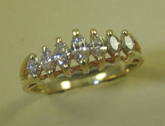 Appraisal: DIAMOND AND FOURTEEN KARAT GOLD RING set with a row