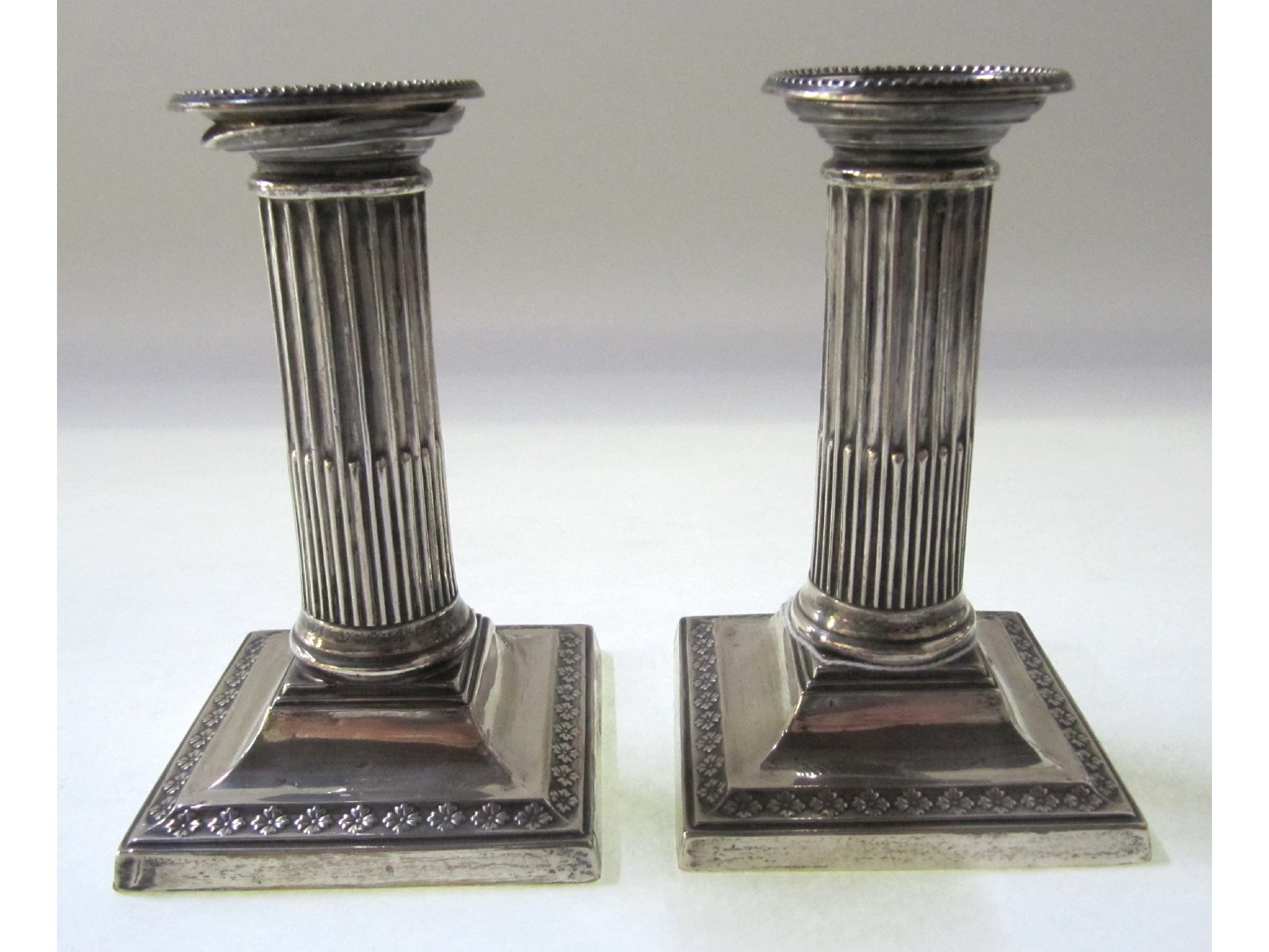 Appraisal: A pair of silver candlesticks with reeded columns London