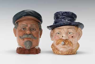 Appraisal: Two Large Male Heads with Mustaches and Hats Majolica head